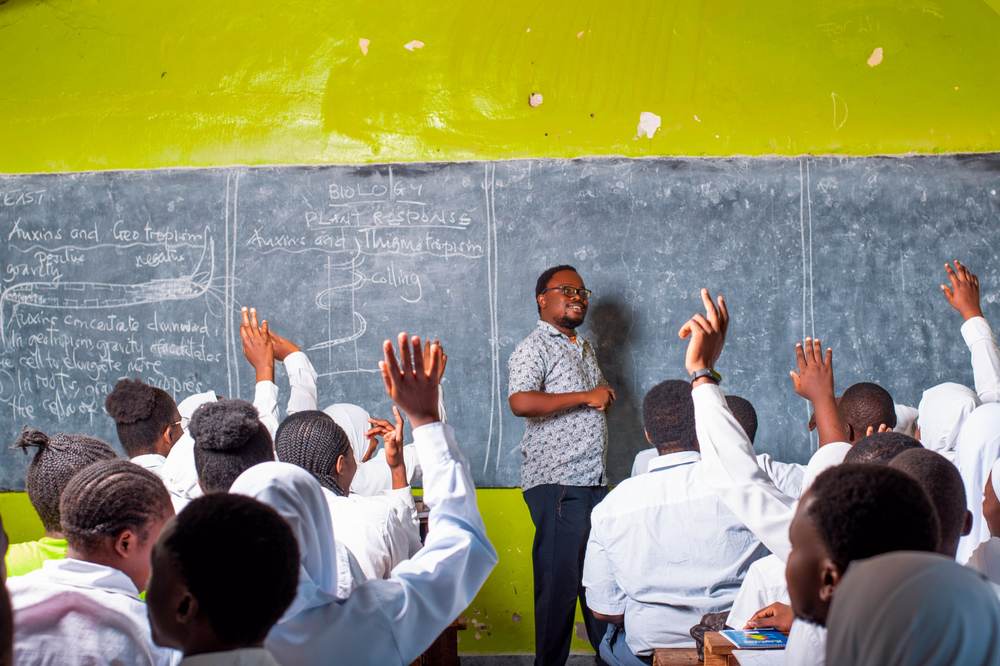 Biology teacher leading a plant response lesson at the blackboard