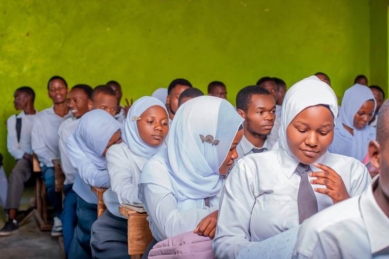 Students seated together taking notes in class